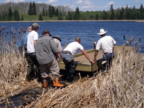 Committee members work on a dock.