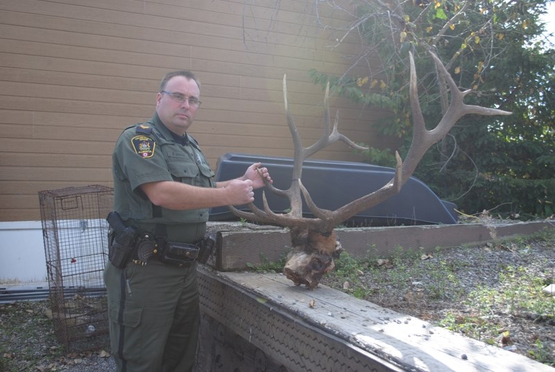 Fish and Wildlife officer Adam Mirus with a seized item.