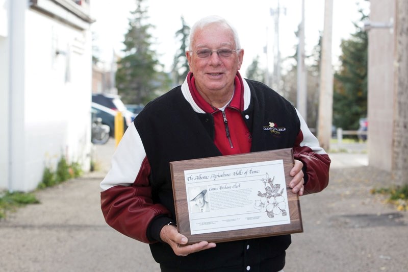 Bob Clark holds plaque