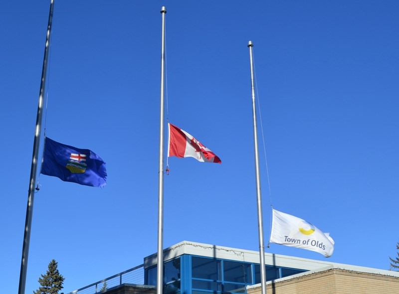 Flags fly at half staff outside the Olds Town Office. Flags were lowered on government buildings across Canada following the Ottawa attacks.