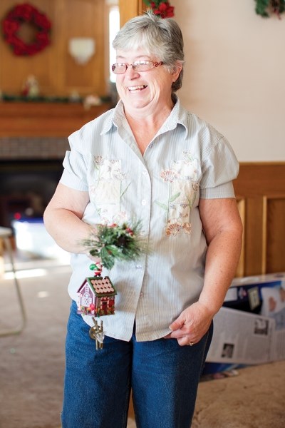 Susan Page helps put up Christmas decorations.