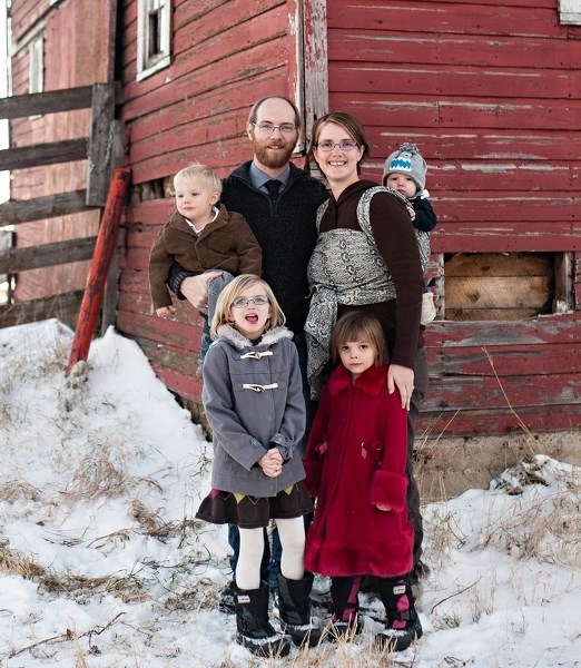 Olds-Didsbury-Three Hills Wildrose Constituency Association president Michael Robertson poses with his family at the farm he operates with his dad and grandfather. Robertson