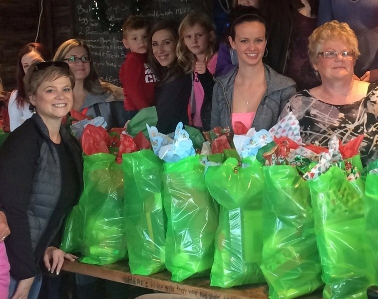 Former Innisfail-Sylvan Lake MLA Kerry Towle, far left, joined dozens of volunteers to make 52 &#8216;Baskets of Hope&#8217; for women at the Central Alberta Women&#8217;s