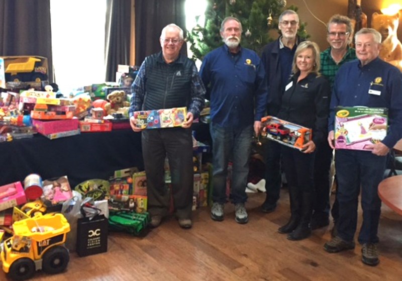 Don and Gwen Day, second and third from right, and members of the Carstairs Lions Club Christmas hamper program hold some of the many gifts collected for local kids.