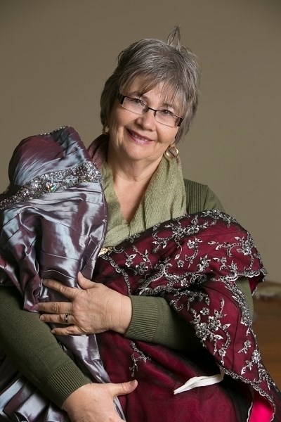 Karen Grudesky with some of the donated dresses she is collecting under the Gowns For Grads project.