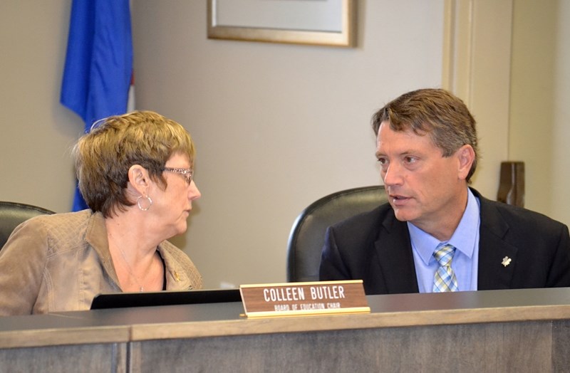 Colleen Butler, chair of the board for the Chinook&#8217;s Edge School Division, and Kurt Sacher, superintendent of schools, talk over an item of concern during the