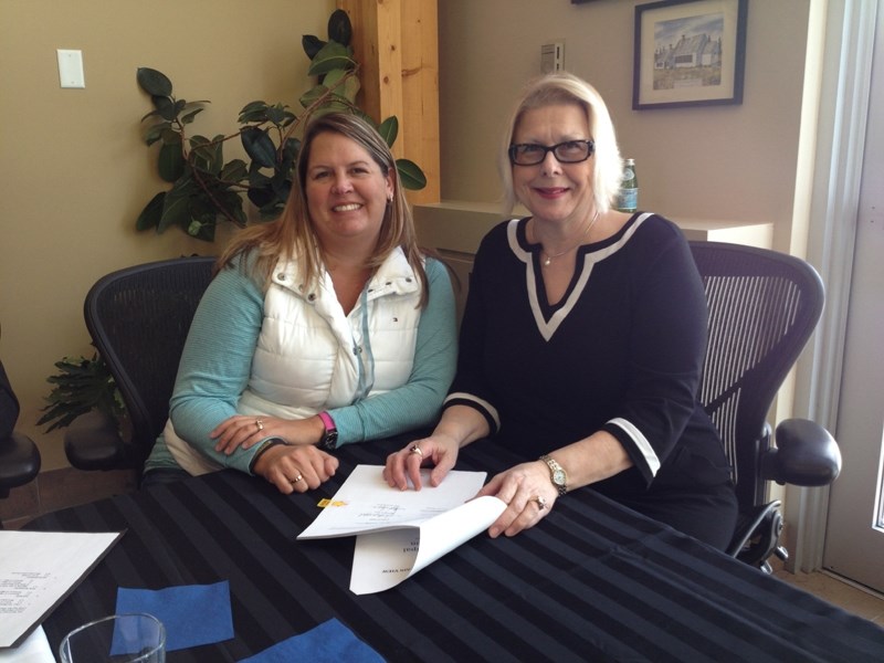 Mountain View County deputy reeve Patricia McKean, left, and Olds mayor Judy Dahl share a smile immediately following the signing of a new inter-municipal co-operation master 