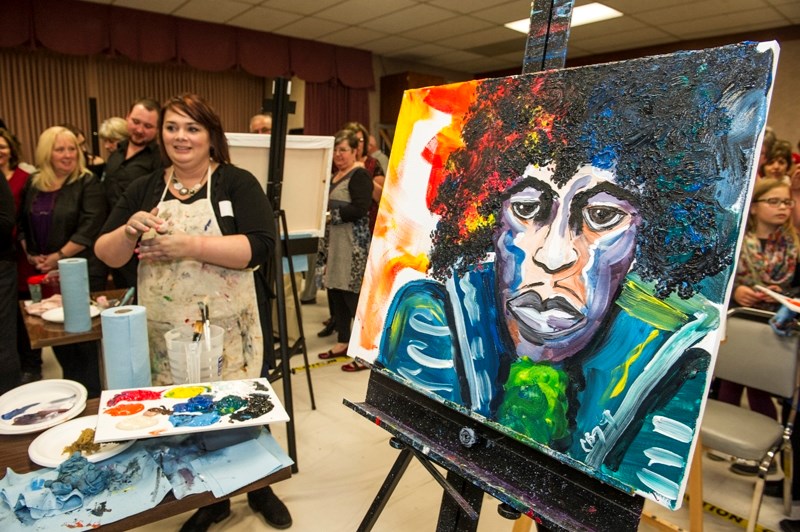 Didsbury artist Cali Beazley with her finished piece &#8220;Jimi&#8221; from the 2015 Art Battle Olds.