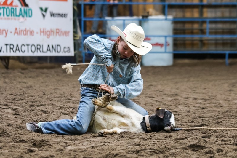 Jayce McKean competes in goat tying.