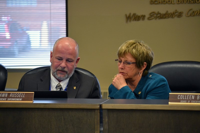 Shawn Russell, associate superintendent of corporate services for Chinook&#8217;s Edge, and board chair Colleen Butler confer on a transportation issue during the school