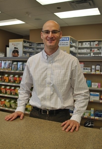 Jody Keller, longtime pharmacist and owner of Pharmasave in Carstairs and Didsbury, stands behind the counter at Carstairs Pharmasave on Feb. 24. Both pharmacies are