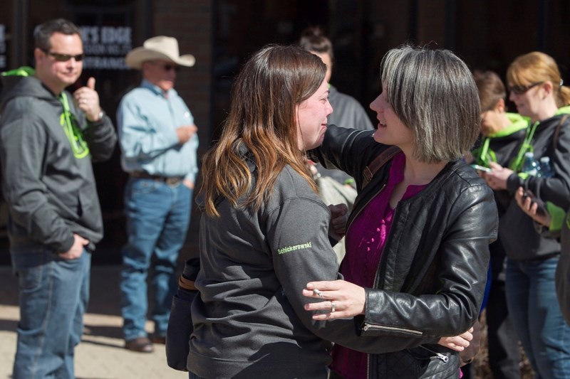 Angie Schickerowski, left, a key member of the Benalto Review Committee trying to save the community&#8217;s school, is consoled by a supporter following the decision on