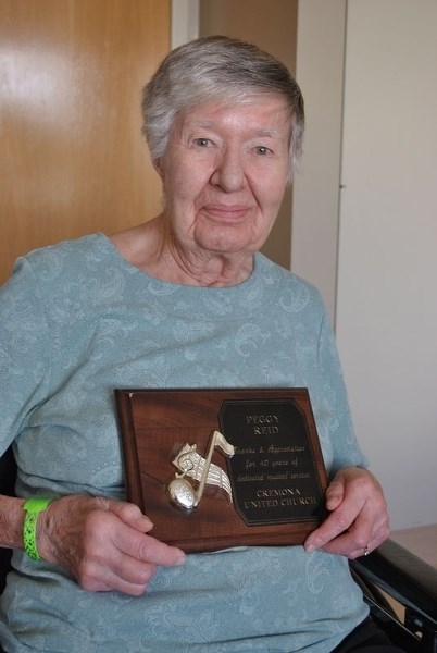 Peggy Reid poses for a photo at the Didsbury hospital on April 6 with a 40 years of service award she received several years ago from the Cremona United Church.