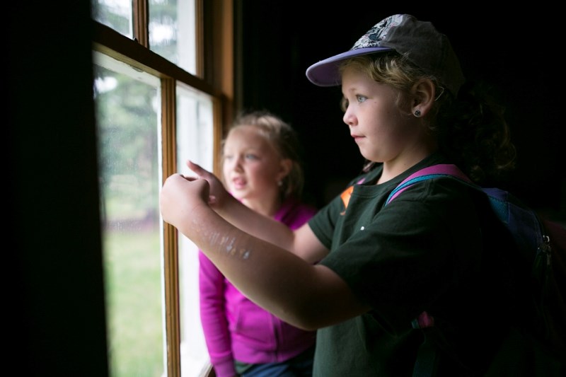 Reed Ranch School Grade 1 students Lola Burke, left, and Trista Damon look out the window of St. Martin&#8217;s Church during a full-school field trip to Heritage Park in