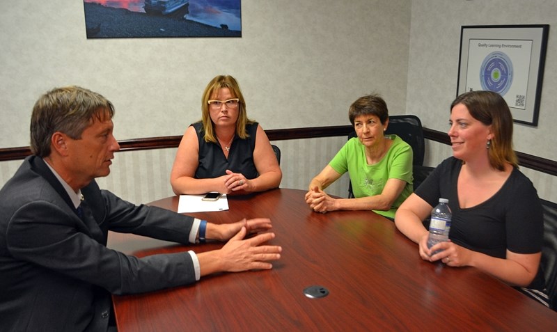 Kurt Sacher, superintendent of schools for the Chinook&#8217;s Edge School Division, talks with members of the Benalto Review Committee following their presentation to board