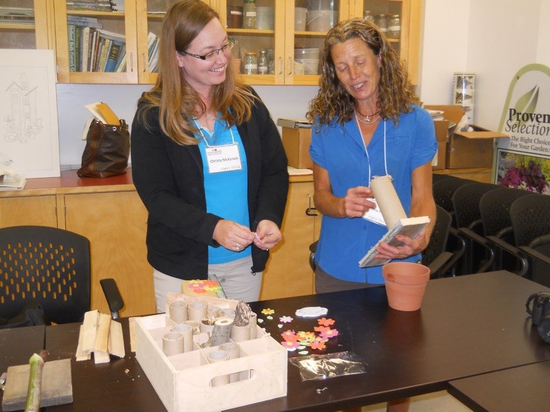 Christy McKenzie, left, shares a smile with instructor Cynthia Pohl during the Introduction to Pollinators workshop held during Hort Week 2016 at Olds College.