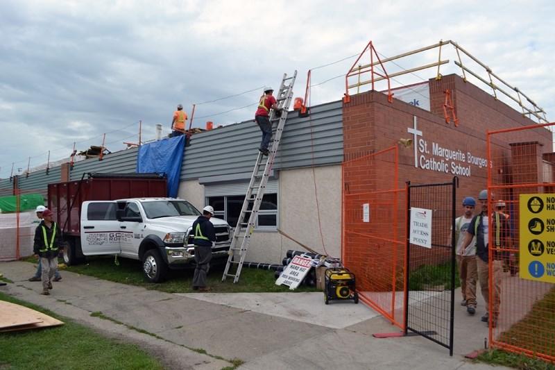 Construction workers continue to work on modernizing the roof at Innisfail&#8217;s St. Marguerite Bourgeoys Catholic School. On Sept. 1, most of the student body officially