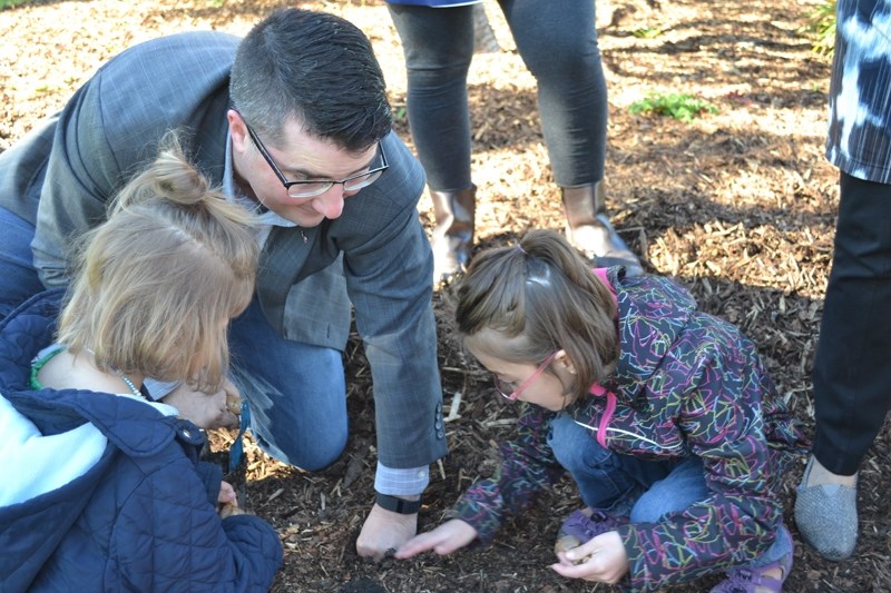 Olds-Didsbury-Three Hills Wildrose MLA Nathan Cooper helps his daughters Paxton, right, and Peyton plant daffodil bulbs during a recent ceremony in Olds.