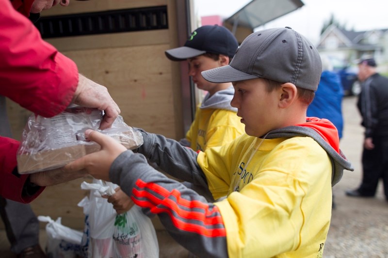 Jacob Fifield unloads donations into a trailer.