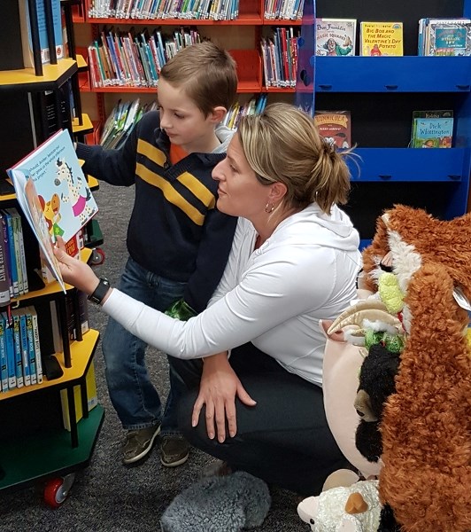 Isaac and mom Charmaine visit the library.