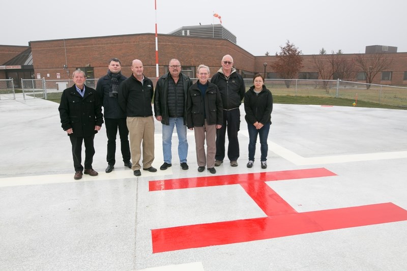 From left, Albert Ohlhauser, Olesky Skoblo, Grant Canning, Terry Blom, Clem Kuelker, Klaus Reimer and Jung Hyun Kim at the Didsbury hospital&#8217;s new helipad on Oct. 25.