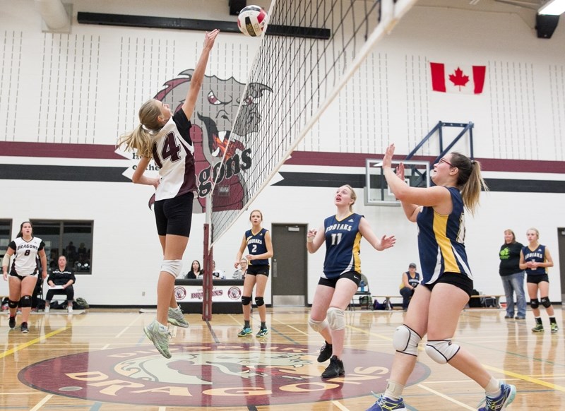 Didsbury High School Dragons junior varsity player Kassi Hatcher spikes the ball.