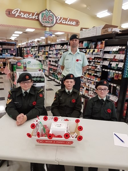 Captain Tim Kaczmarski and Didsbury army cadets Master Cpl. Knipe, Cpl. Hodges and Master Cpl. Hodge sell poppies at AG Foods in Didsbury on Nov. 5. Kaczmarski is taking over 