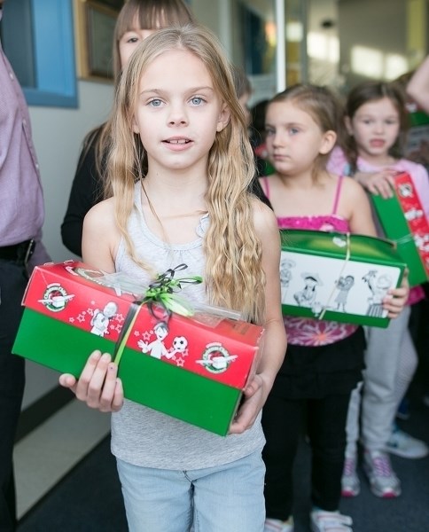 Carstairs Elementary School student Calli Allison and her fellow students help load Operation Christmas Child shoeboxes into a van.