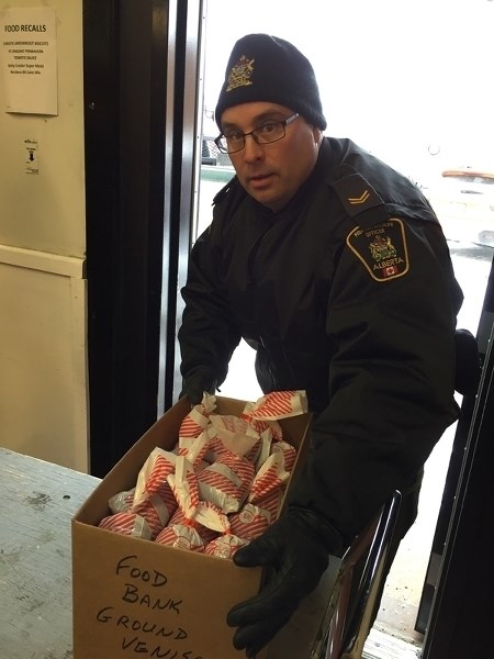 District Fish and Wildlife officer Adam Mirus unloads donated meat at the Mountain View Food Bank on Dec. 6