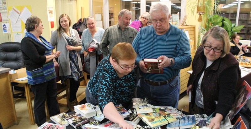 The Didsbury Municipal Library held an open house and volunteer appreciation evening on March 6. Pictured are three of the many volunteers, from left, Cathy and Frank Grills