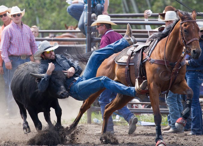 Chance Boomer leaps onto a steer during the steer wrestling competition.