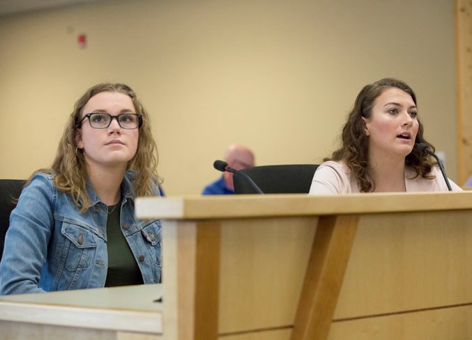 Mateya Selders, right, and Meg Kennedy speak with county council on July 3.