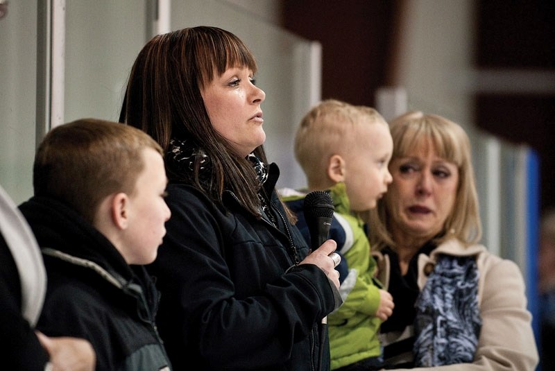 Jaimie Waugh, along with her mother and two sons, Rylen and Oliver, addresses the crowd and thanks them for their support at the Waugh/Allan Eagles Alumni Charity Game on