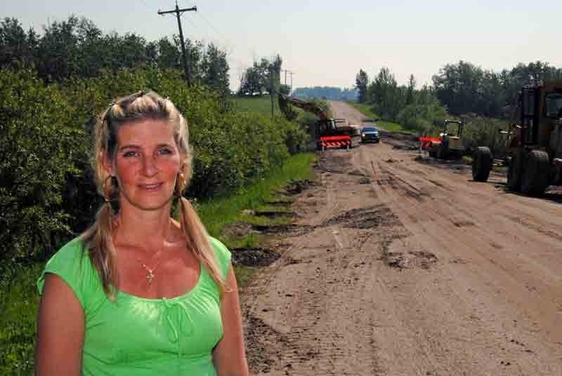 Chinook&#8217;s Edge school bus driver Tammy Bodman, 38, stands metres away from where her bus drove over a washed-out portion of Twp. Rd. 350 last week. Bodman said the