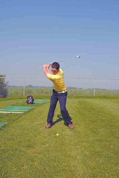 Kirk Williscroft, an assistant professional at the Innisfail Golf Club takes a swing on the club&#8217;s driving range. Williscroft recently received his CPGA professional