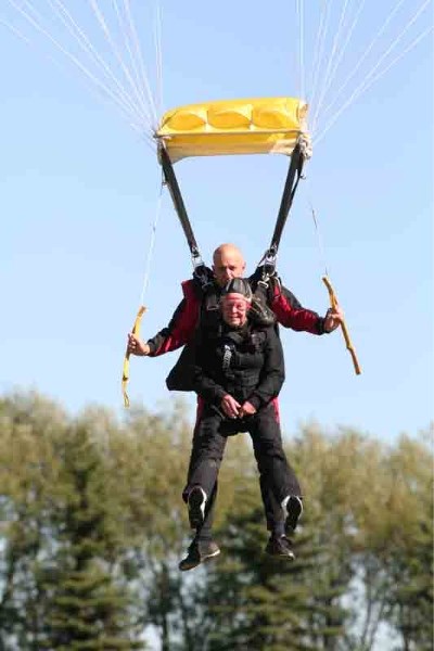 Patti Clark, 80, and her tandem master, John &quot;J.T.&quot; Thiessen, come in for a landing at Innisfail&#8217;s Big Bend Airport on Sunday morning. It was the first