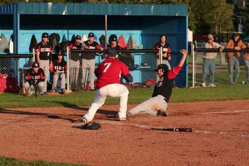 Rocky&#8217;s Scott Hornstra scores during the seventh inning of Friday&#8217;s game as Innisfail Indians&#8217; pitcher Jay Kirkham waits for the throw. The Red Dogs rallied 