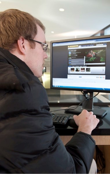 Jody Young, uses the new computers to borrow films, and watch videos online Feb. 22&lt;br /&gt;Photograph By: Andrew Crossett