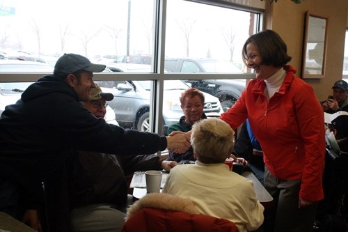 Premier Alison Redford shakes hands with Andrew Glazebrook during a first-day campagin stop at the Innisfail Tim Hortons on March 26.