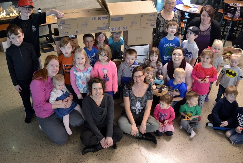 Children, parents and organizers of Innisfail&#8217;s first ever Cardboard Box Challenge at Innisfail Library/Learning Centre on Feb. 22 pose for a group photo under a stack