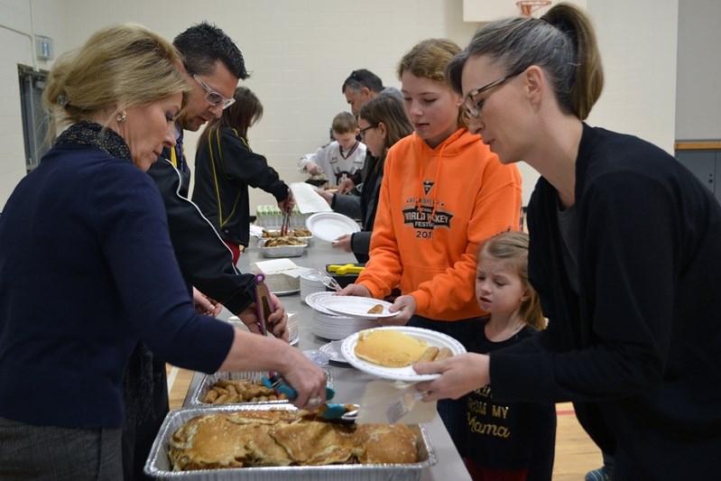 School staff serve up pancakes and sausages to parents, guests and students early in the morning on Shrove Tuesday on Feb. 28.&lt;br /&gt;&lt;br /&gt;Johnnie Bachusky/MVP