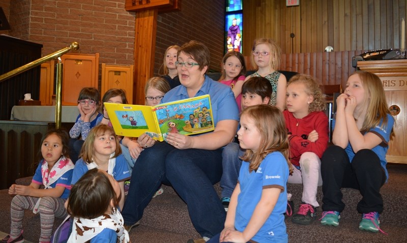 Members of the Golden Poplar District Girl Guides listen to a story about Canada from guider Breanna Suk during the organization&#8217;s Canada 150 event on March 18 in