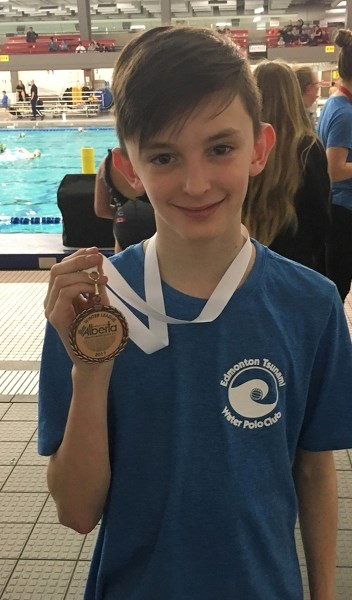 Jacob Mydland proudly shows off his bronze medal he won with the Edmonton Tsunami U-14 boys team at the Alberta Water Polo winter league provincials in Edmonton April 8 and 9.