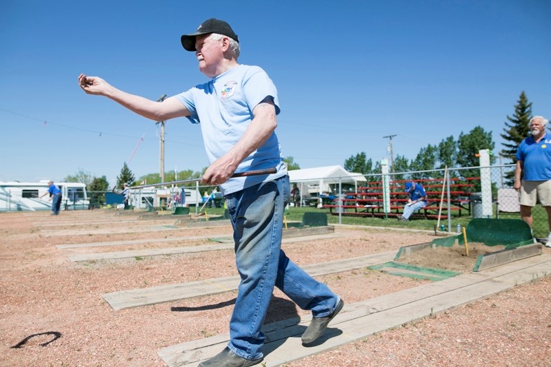 Scotty Miller throws a horseshoe during the Innisfail Legion Open Horseshoe Tournament on May 27.