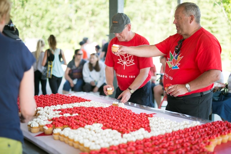 Mayor Brian Spiller hands out more than 800 Canada 150 cupcakes during the June 30 Canada 150 party at Centennial Park, which were collectively displayed in a Canadian flag