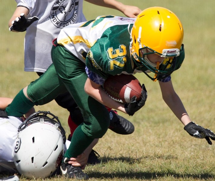 A Rocky Mountain Jr. Rebels peewee player has no where to go on the field after being caught by a Red Deer Hornet player during the team&#8217;s game.