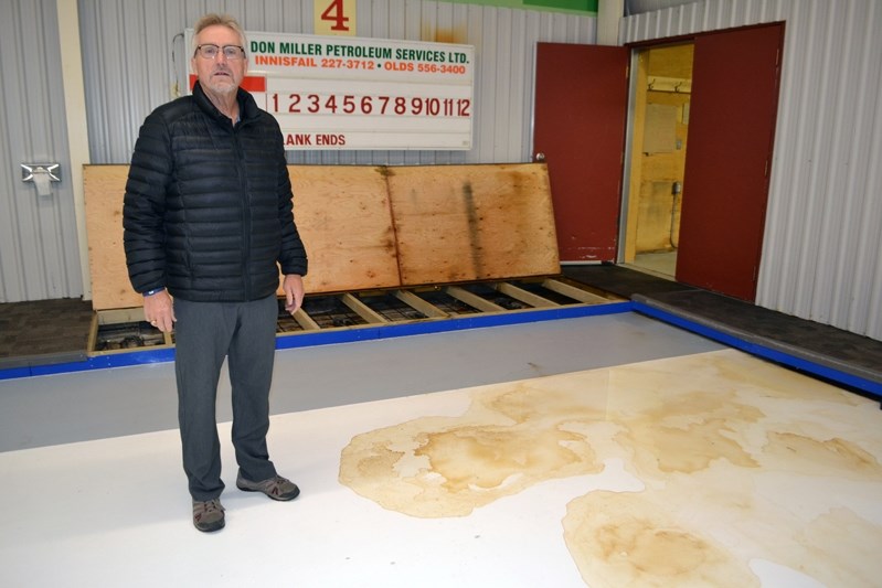 Lowell Peterman, icemaker and manager at the Innisfail Curling Club, stands by an ice floor stain that was caused by a leak from the damaged roof during last week&#8217;s