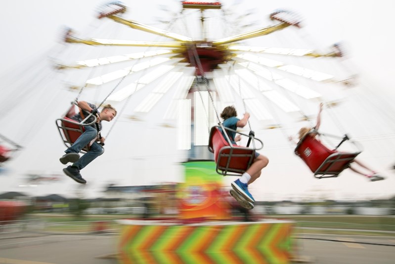 Young Penholders circle on a midway ride during the Penhold Fall Festival on Sept. 8.