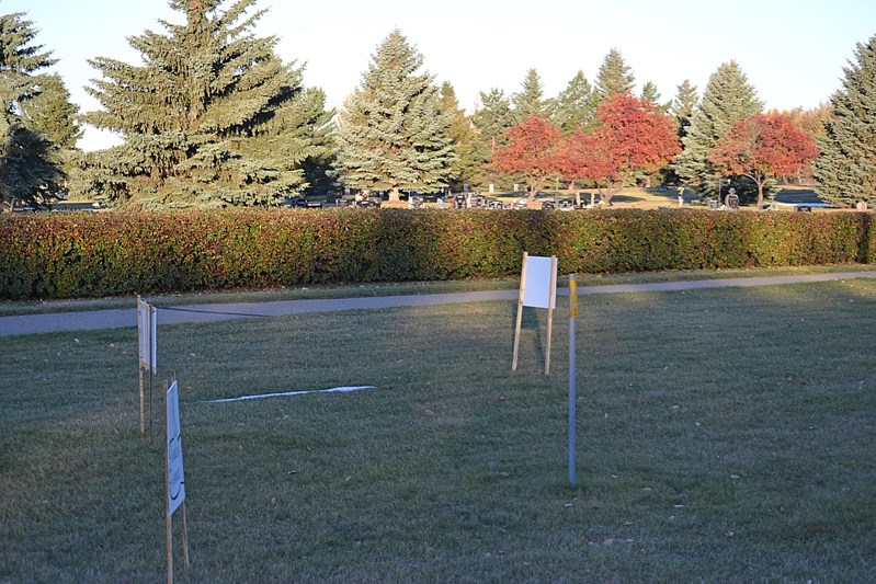 Election signs placed in front of the Innisfail Cemetery.