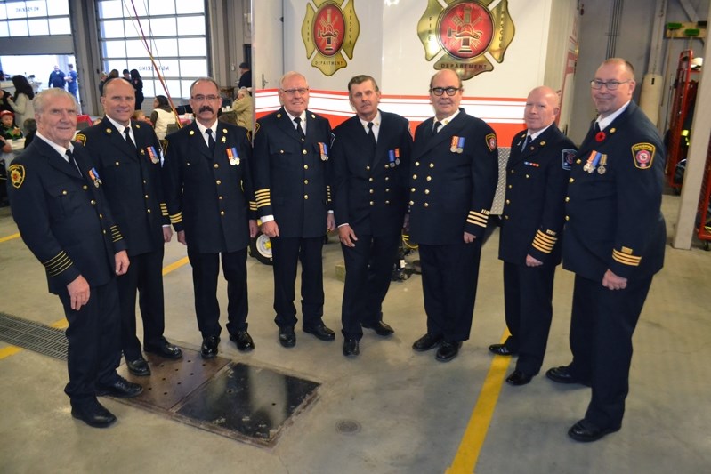 Seven of Innisfail&#8217;s finest line up with Innisfail fire Chief Gary Leith last week before receiving a Municipal Long Service Award and an Alberta Emergency Services